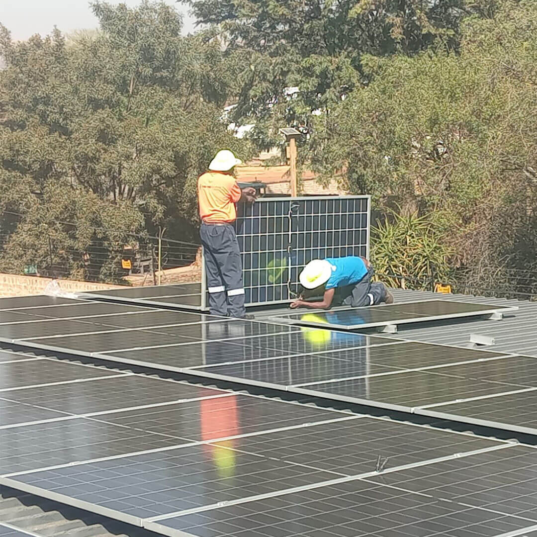 An image of solar panels being installed on the roof of a factory by Energilitical Electrical Engineering specialists.