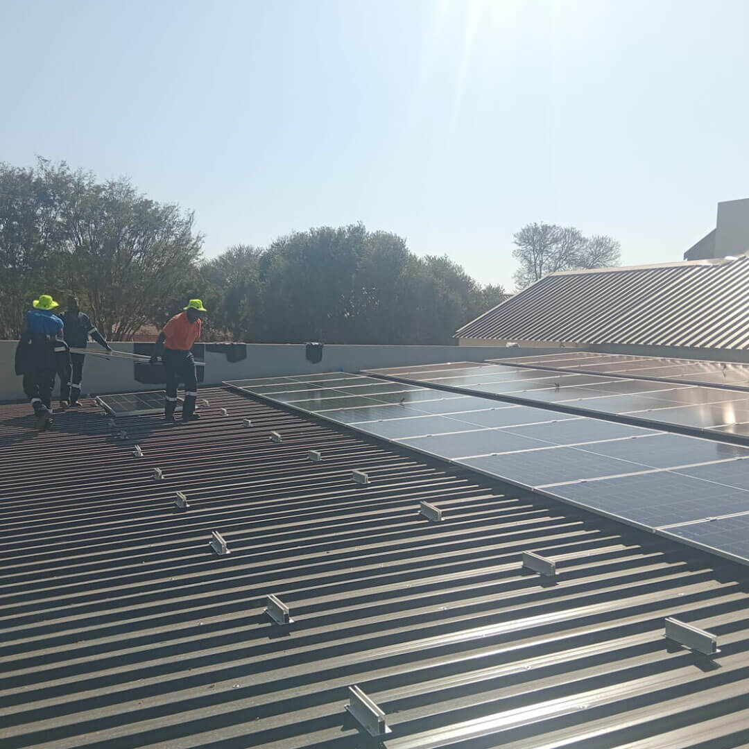 An image of solar panels being installed on the roof of a factory by Energilitical Electrical Engineering specialists.