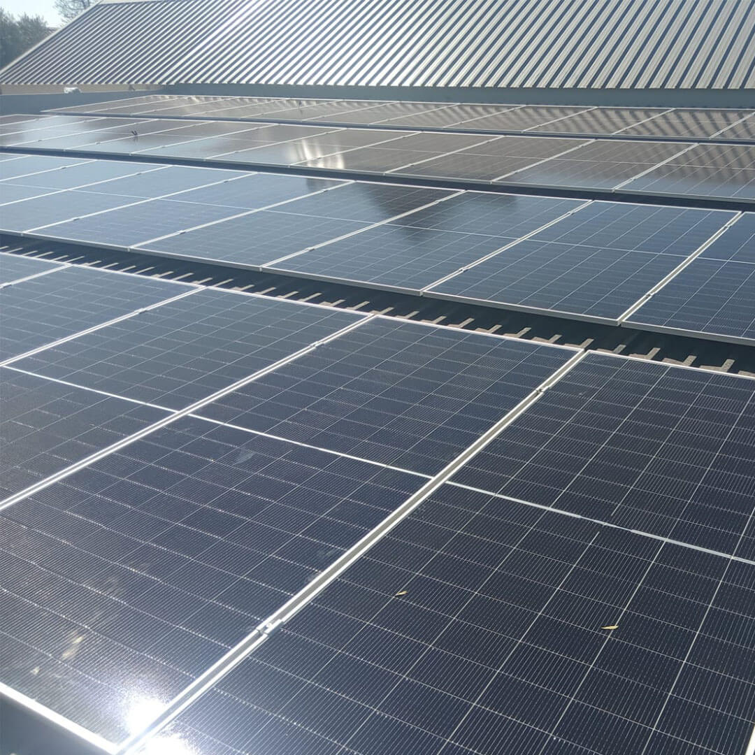 An image of solar panels installed on the roof of a factory by Energilitical Electrical Engineering specialists.