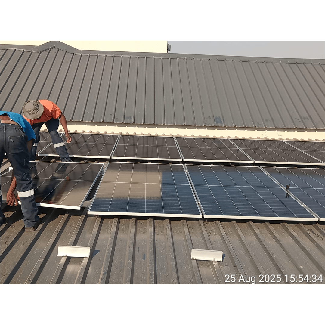 An image of Energilitical engineers installing Solar panles on a industrial roof.